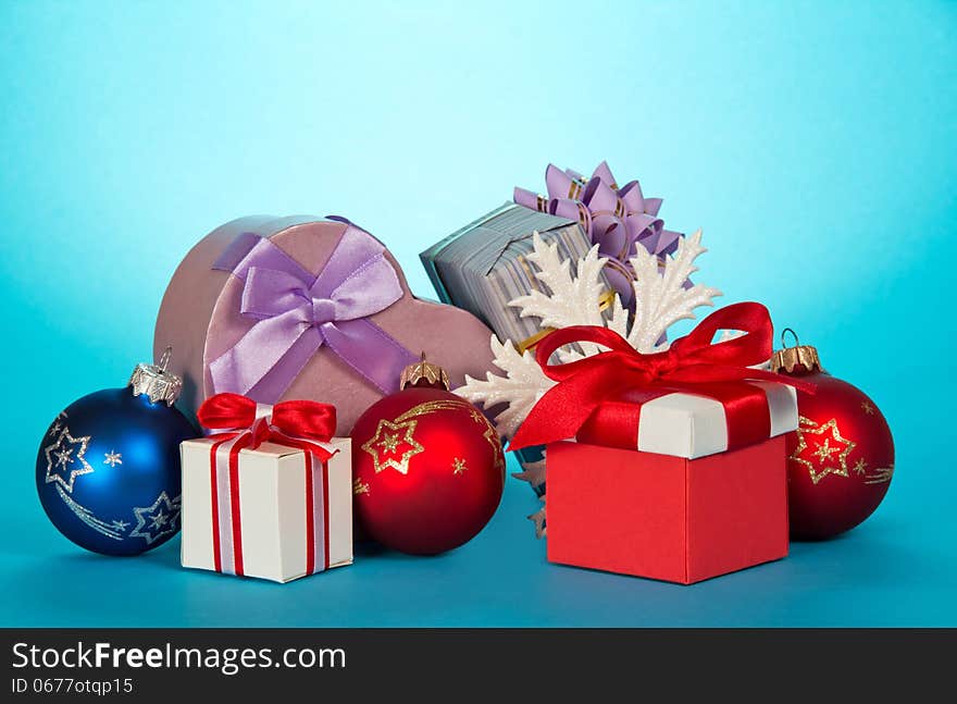 Various gift boxes and beautiful Christmas toys on a blue background