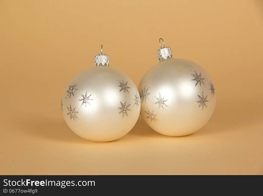 Two beautiful Christmas toys on a beige background