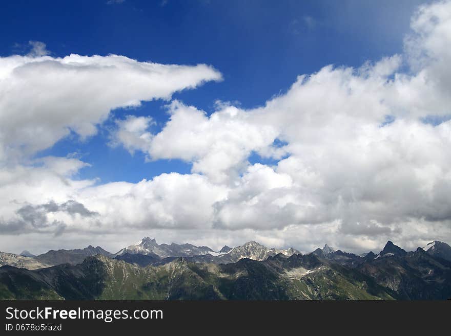 Mountain peaks in Dombai. Summer in cloudy weather