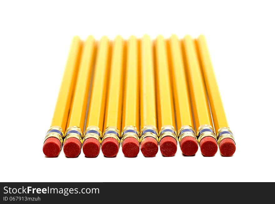 Row Of Yellow Pencils With Erasers In Foreground