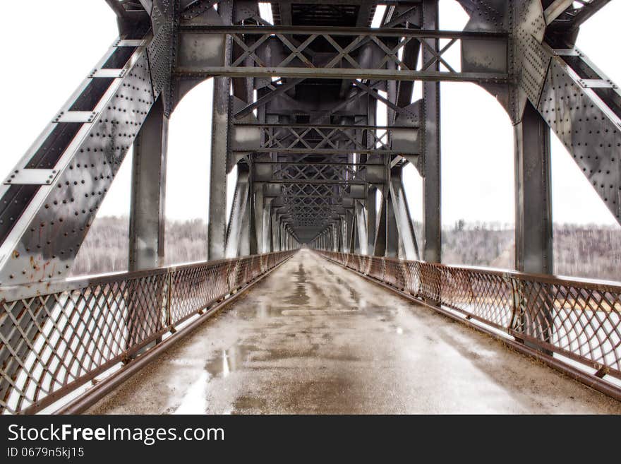 A steel railway bridge over a highway. A steel railway bridge over a highway