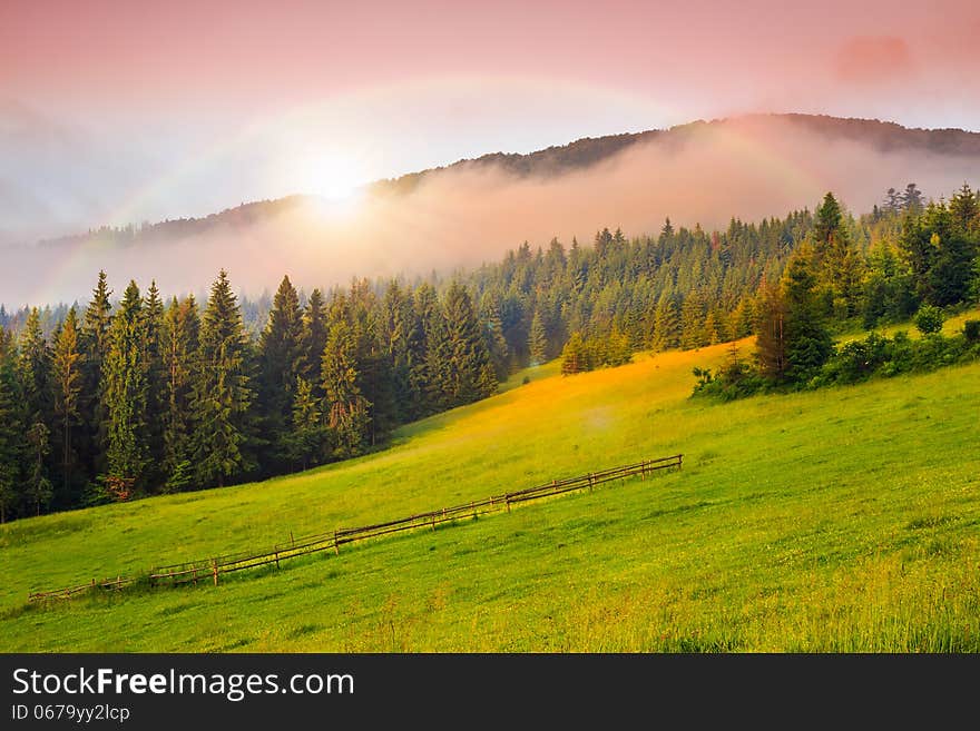 Cold fog on hot sunrise in mountains