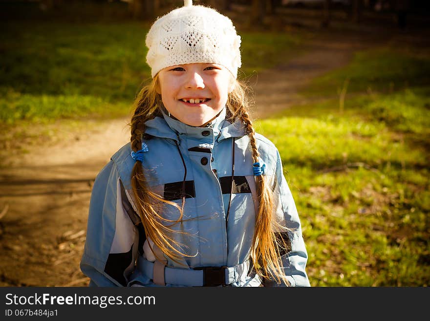 Little girl in park in the autumn