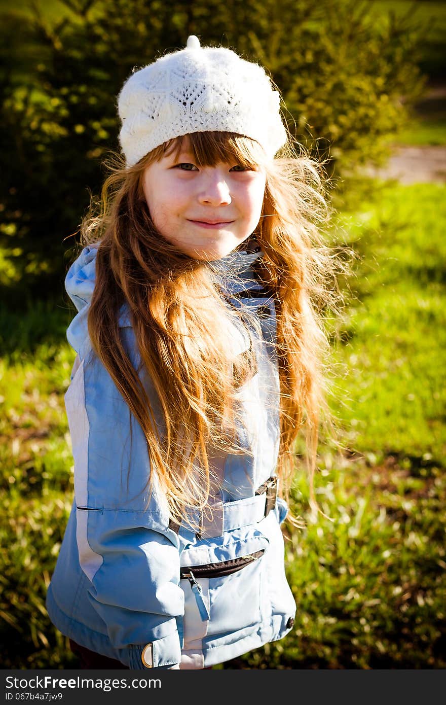 Little Girl In Park In The Autumn