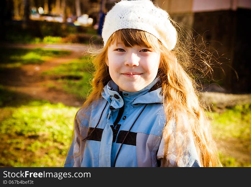 Little girl in park in the autumn