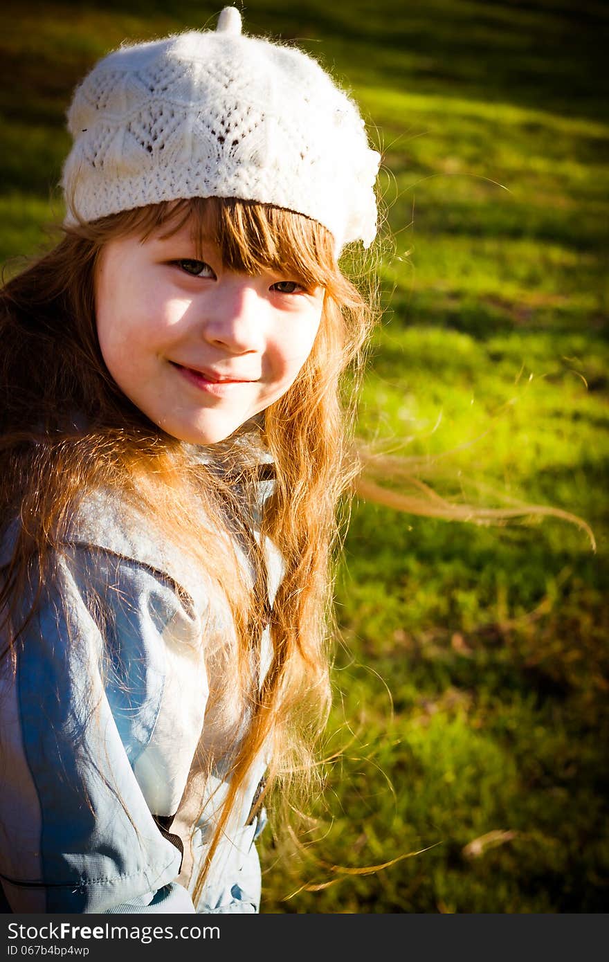 Little girl in park in the autumn