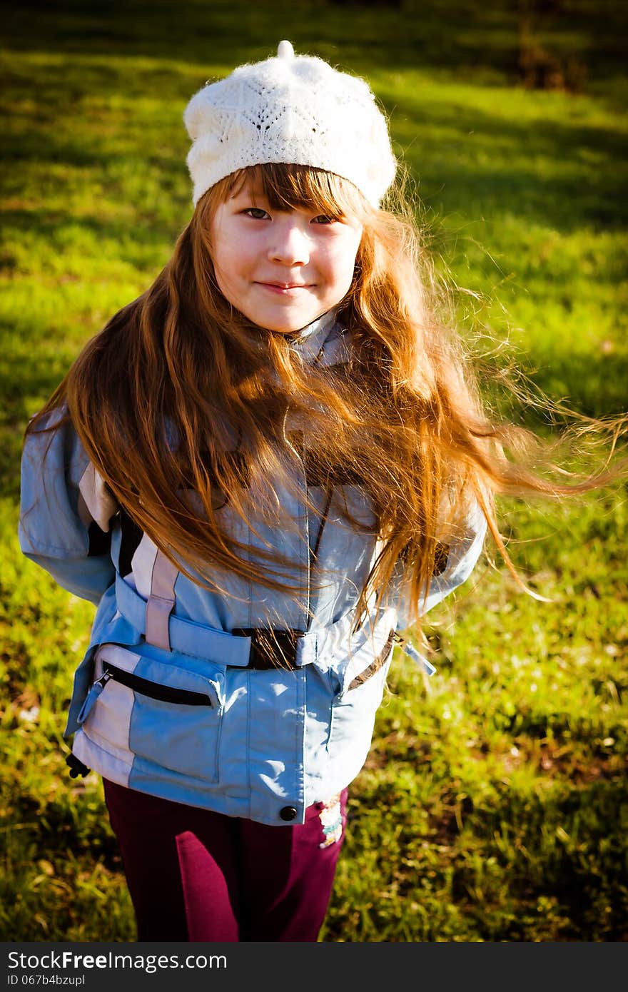 Little girl in park in the autumn