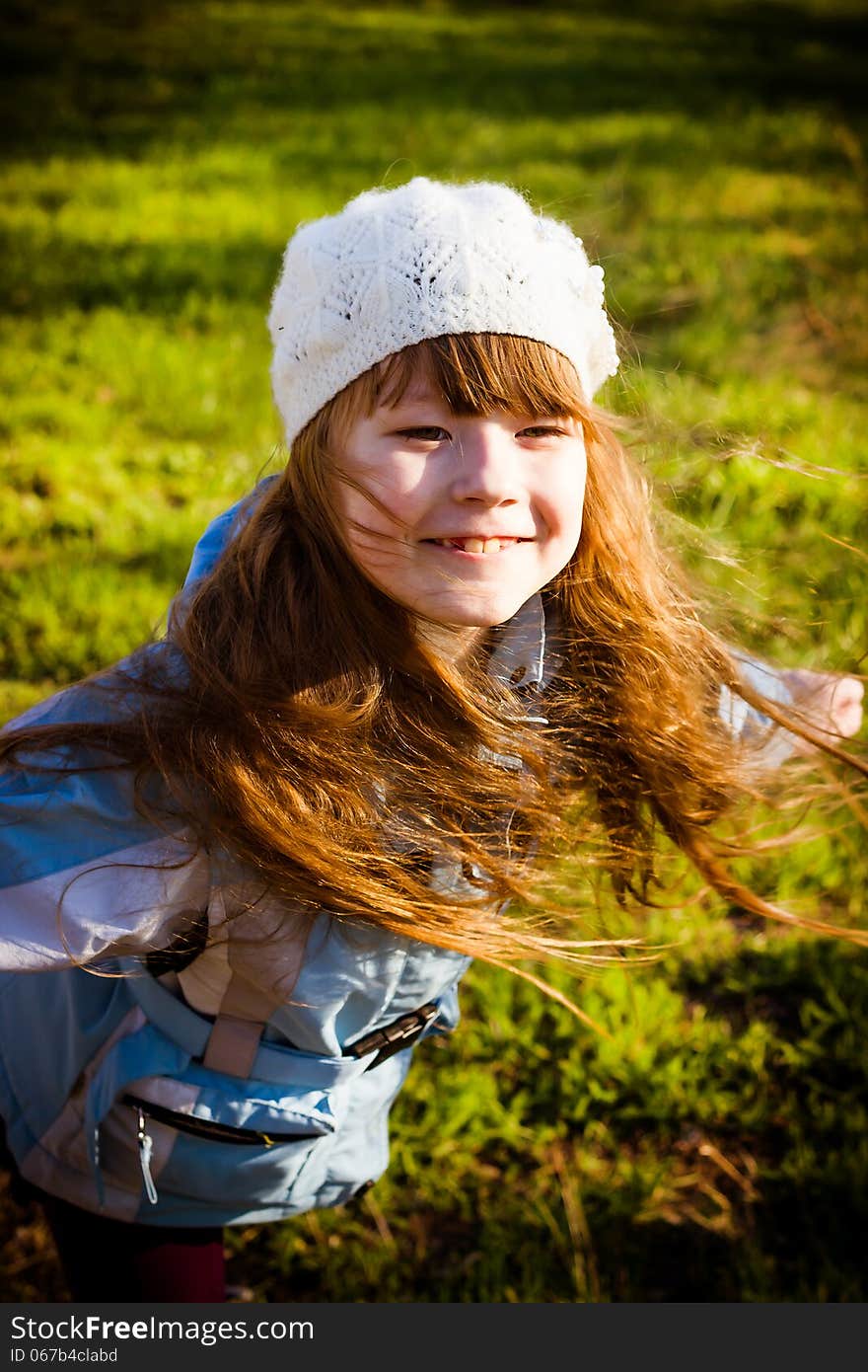 Little girl in park in the autumn