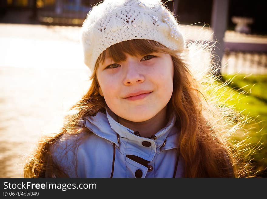 Little Girl In Park In The Autumn