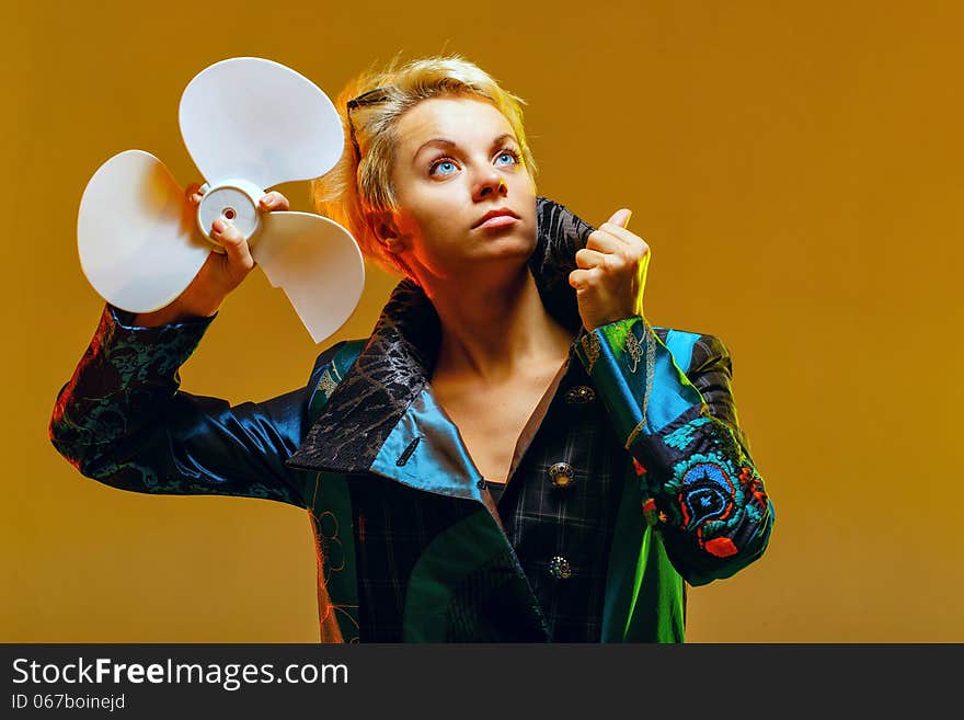 Girl in a jacket with a fan in hands, shot in the studio. Girl in a jacket with a fan in hands, shot in the studio