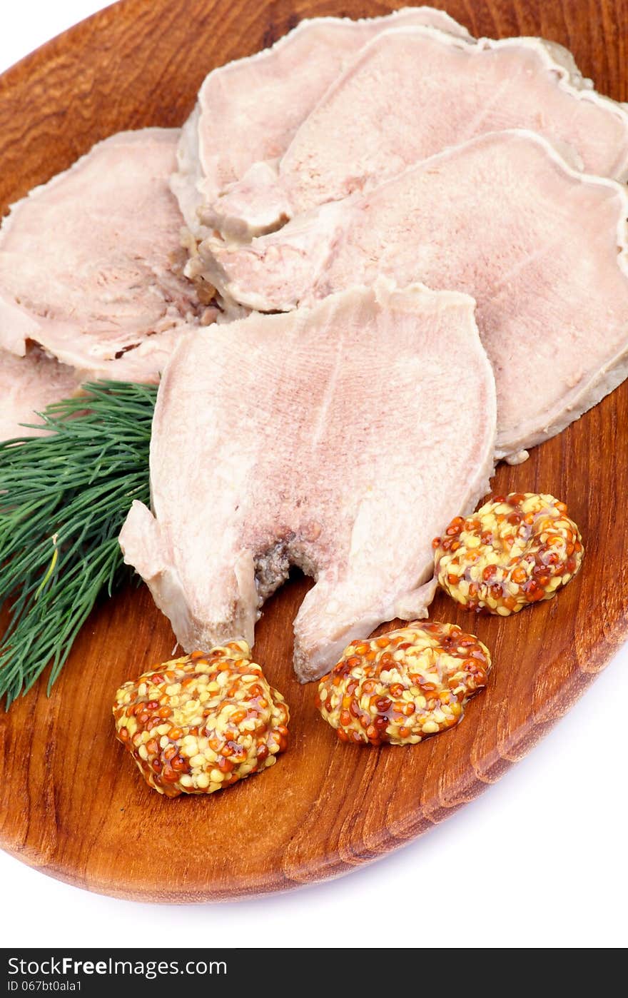 Slices of Delicious Boiled Beef Tongue with Whole Grain Mustard and Dill on Wooden Plate closeup