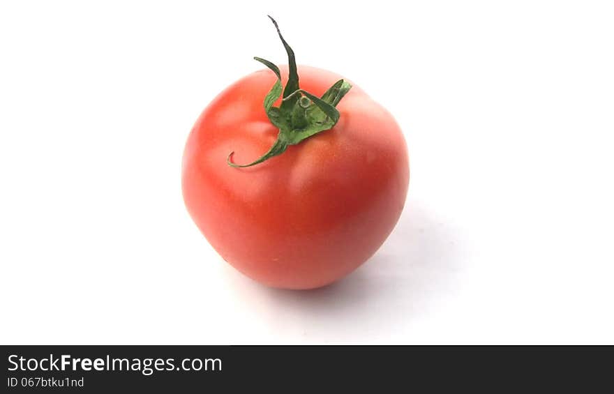 Juicy fresh tomato isolated spins around its axis. Juicy fresh tomato isolated spins around its axis