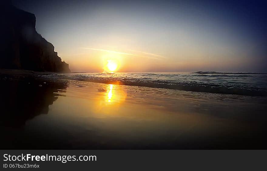 Sandy beach. Early in the morning. Lowest point shooting. Tidal bore rises above the level of the camcorder lens. Sandy beach. Early in the morning. Lowest point shooting. Tidal bore rises above the level of the camcorder lens