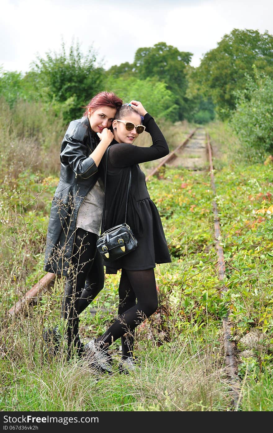 Two girls hugging outside smiling. Two girls hugging outside smiling.