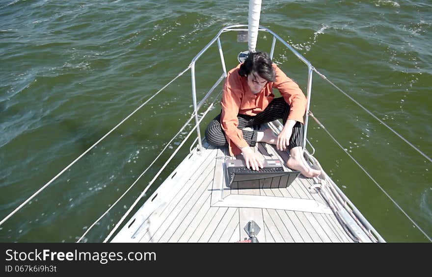 With laptop on a yacht