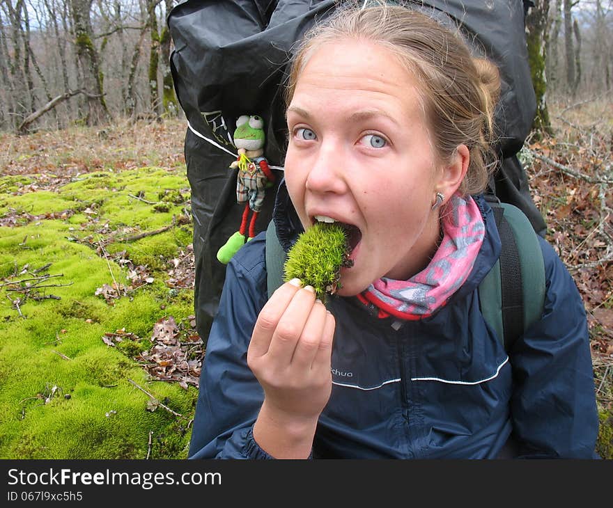 Girl tries lips soft moss. Girl tries lips soft moss