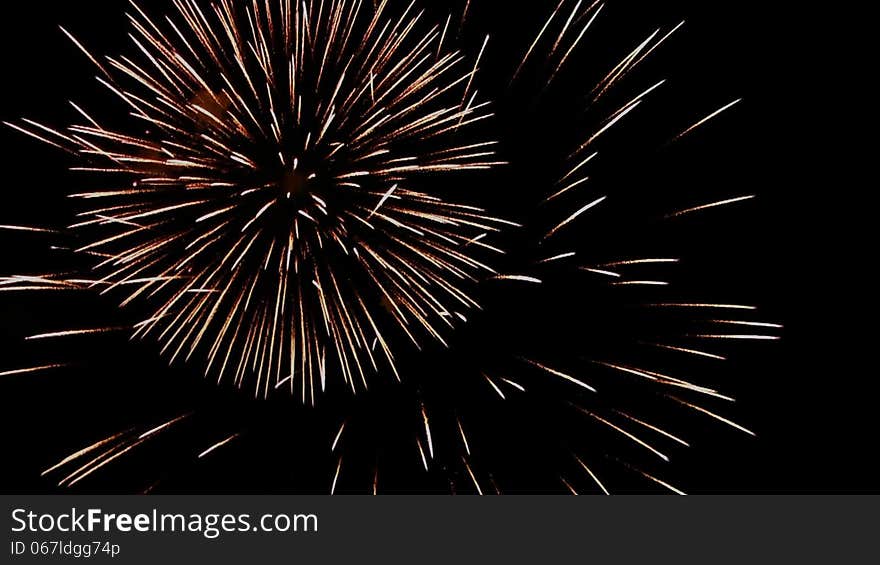 Multi volleys firework splits millions of lights in the night sky. Multi volleys firework splits millions of lights in the night sky