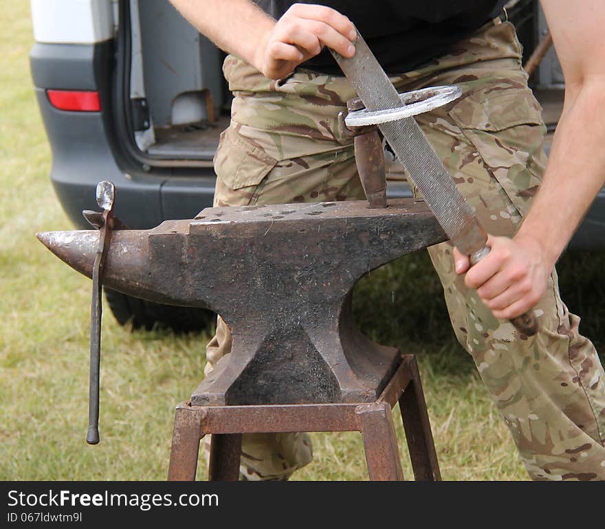 Working on a Horseshoe at a Vintage Blacksmith Anvil.