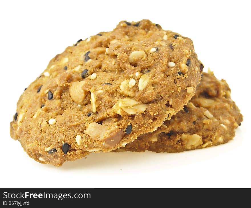 Pair of two delicious whole grains cookies pile on white background. Pair of two delicious whole grains cookies pile on white background