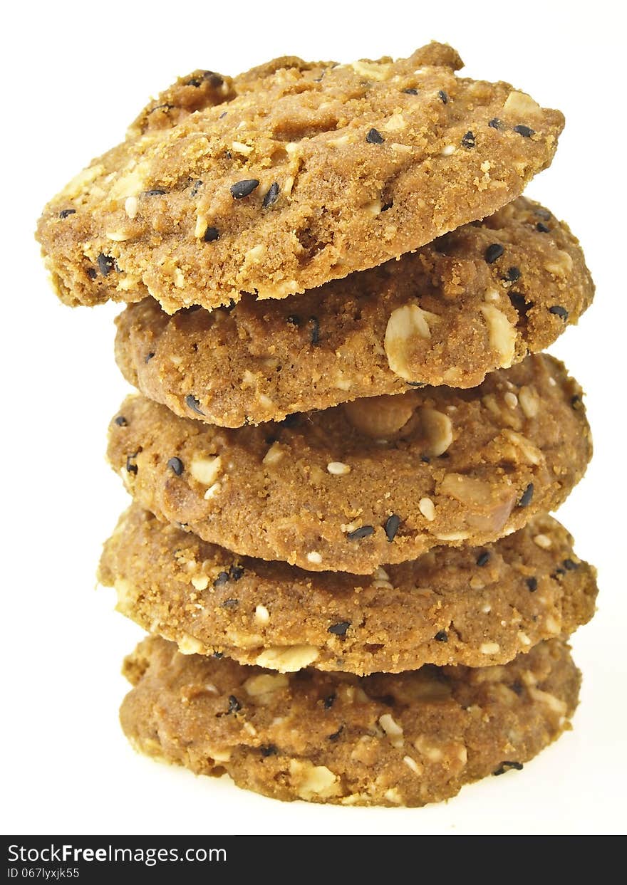 Tilted stack tower of whole grains cookies on white background. Tilted stack tower of whole grains cookies on white background