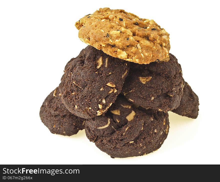 Pile of brownie cookies and light brown cookies on top on white background. Pile of brownie cookies and light brown cookies on top on white background