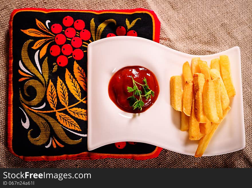 French fries and sauce dish with Russian kvass on traditional napkin. French fries and sauce dish with Russian kvass on traditional napkin