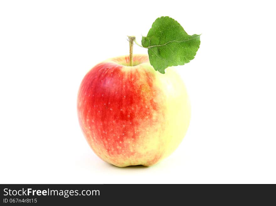 Big red apple with one green leaf isolated on a white background. Big red apple with one green leaf isolated on a white background