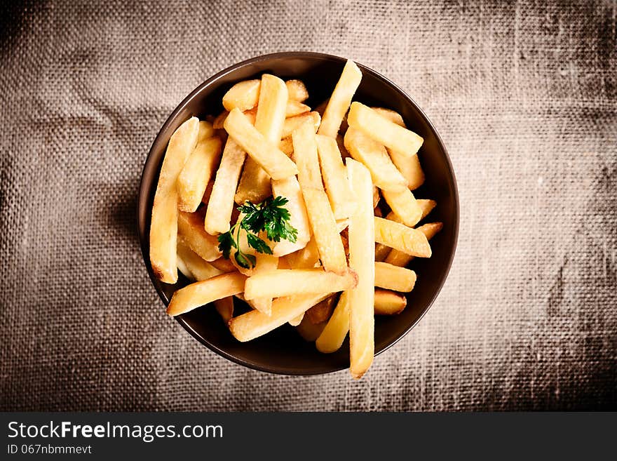 Fried French fries with red sauce ketchup on beautiful plate with linen background. Fried French fries with red sauce ketchup on beautiful plate with linen background