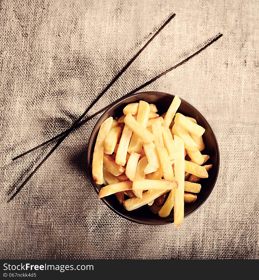 Fried French fries with red sauce ketchup on beautiful plate with linen background. Fried French fries with red sauce ketchup on beautiful plate with linen background