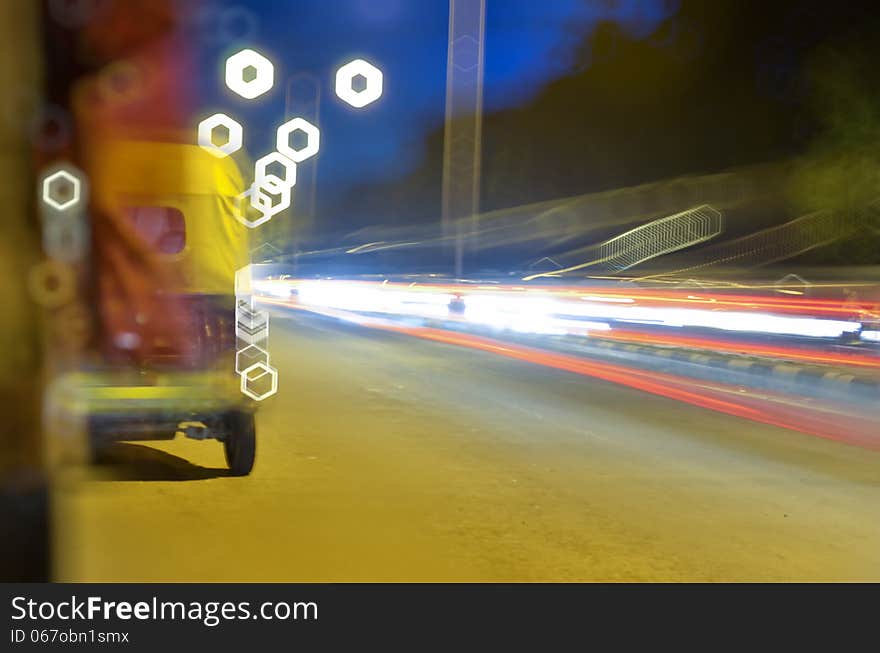 Moving auto rickshaw on road with light trails at night. Moving auto rickshaw on road with light trails at night