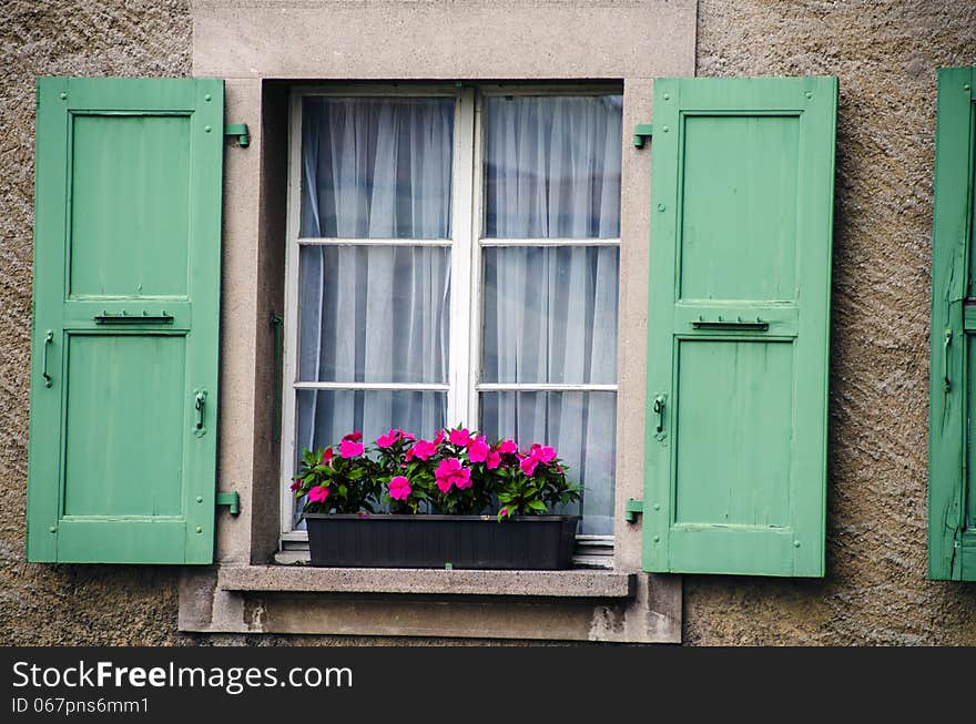 Window wth wood shutters and flowers