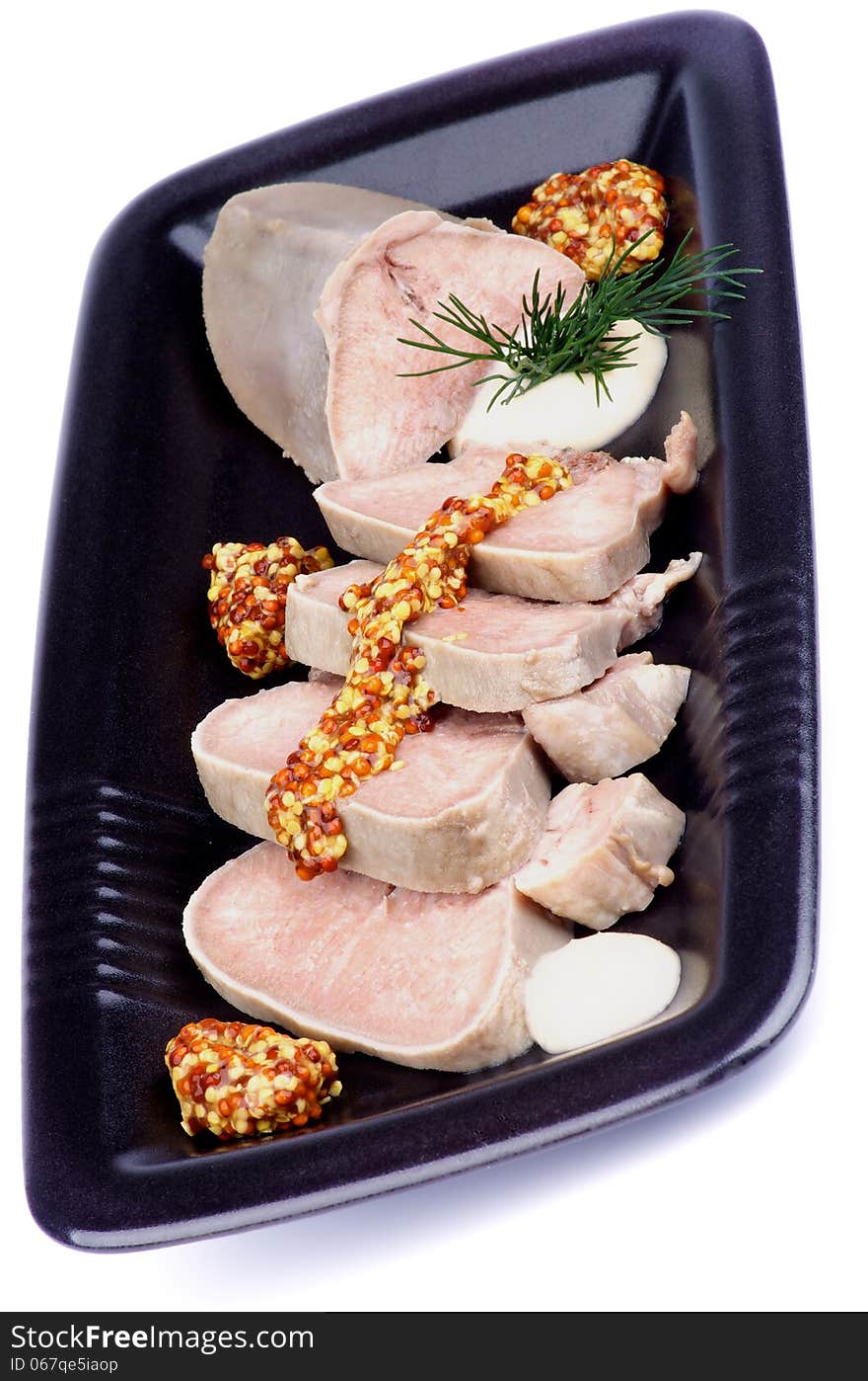 Slices of Delicious Boiled Beef Tongue with Whole Grain Mustard, Horseradish and Dill on Black Plate isolated on white background