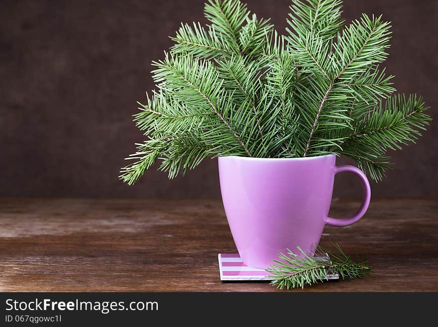 Fir-tree Twigs In A Mug On Old Wooden Table