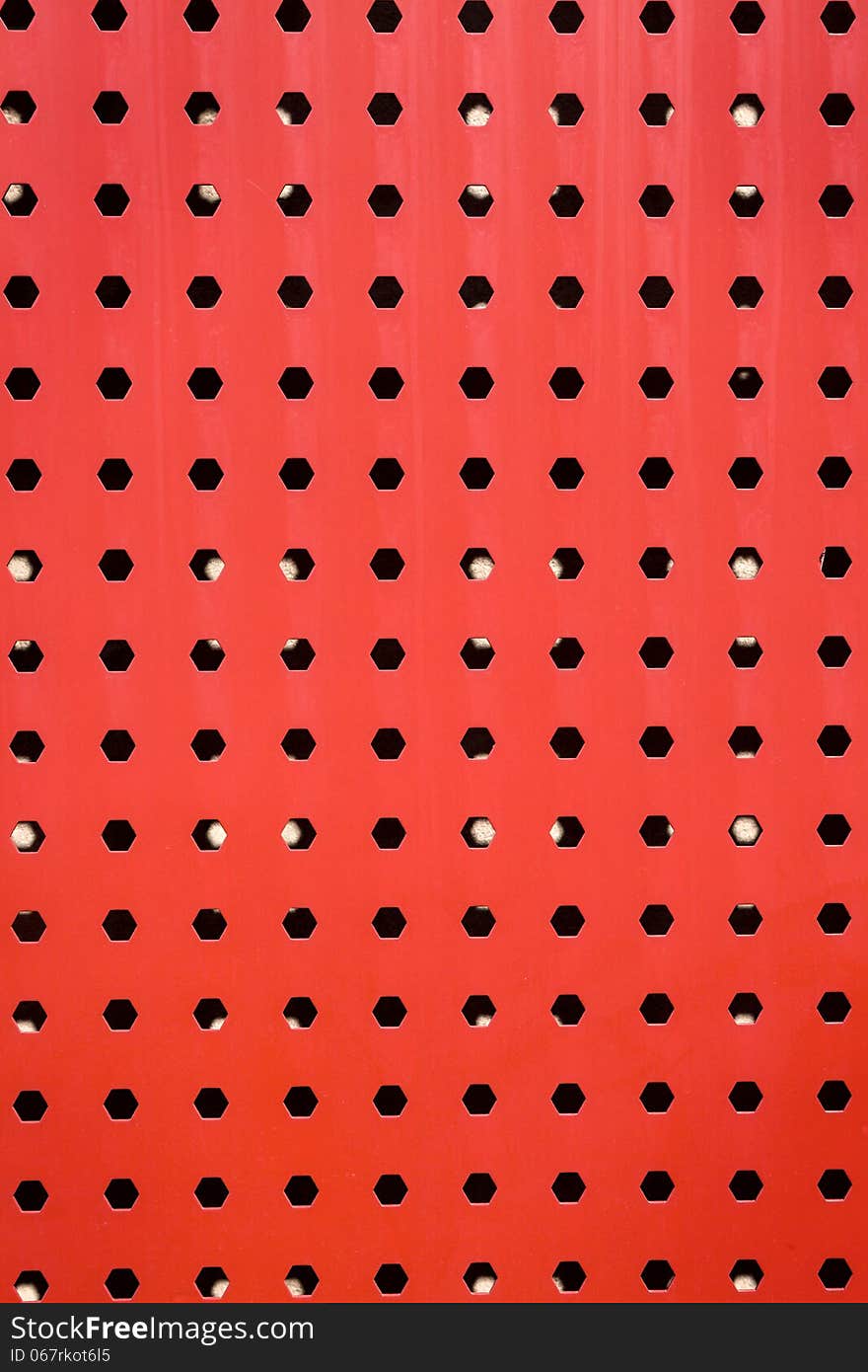 Red steel plate wall with lot of holes. Red steel plate wall with lot of holes