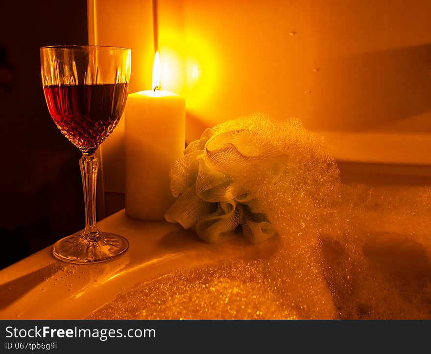 A glass of wine and bubble bath