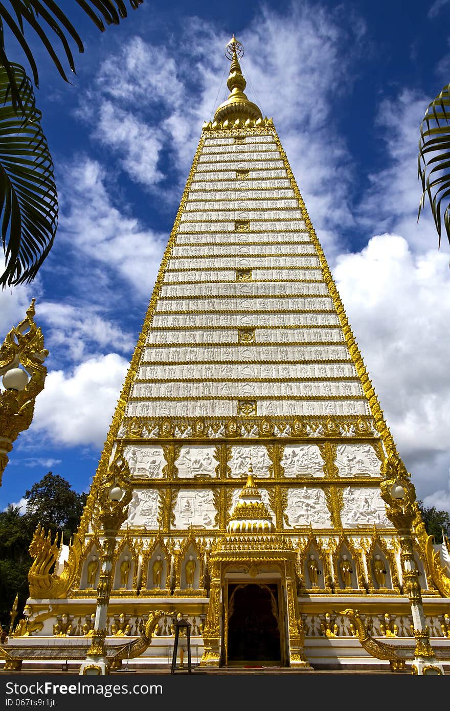 White and gold sharp square pagoda with cloud in temple country of Thailand.