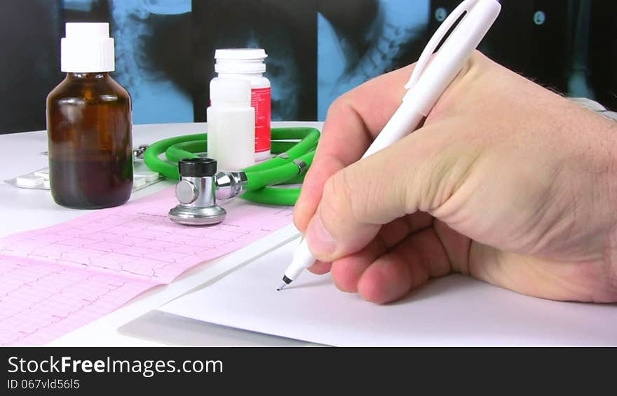 Doctor hand wrote Healthy in Spanish on the background of X-ray images, printed ECG, stethoscope and pills. Doctor hand wrote Healthy in Spanish on the background of X-ray images, printed ECG, stethoscope and pills