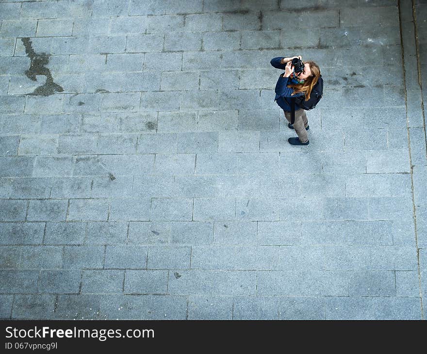 Young Woman Taking Photos On Pavement Backround