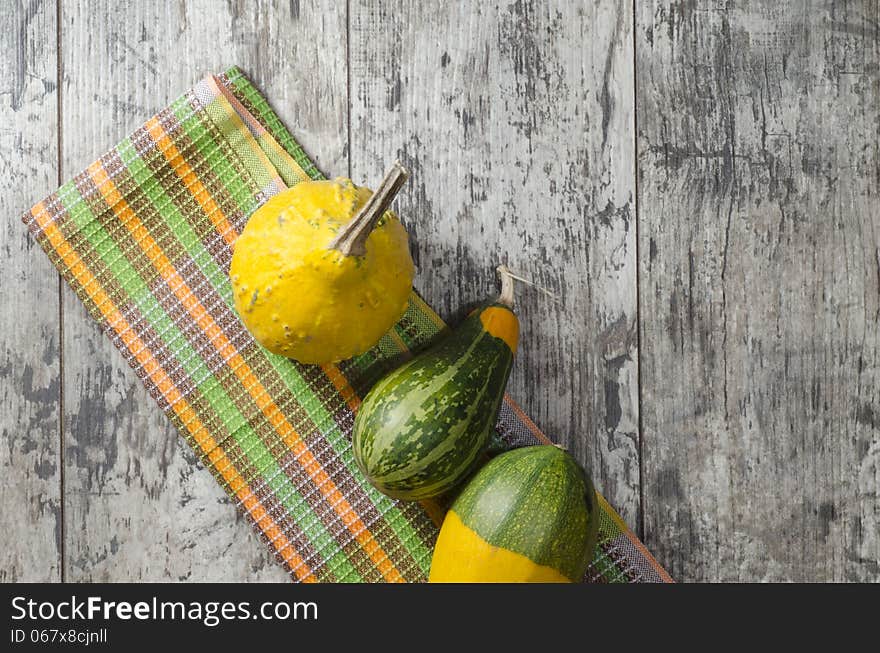 Small pumpkins on old table. From series Pumpkin season