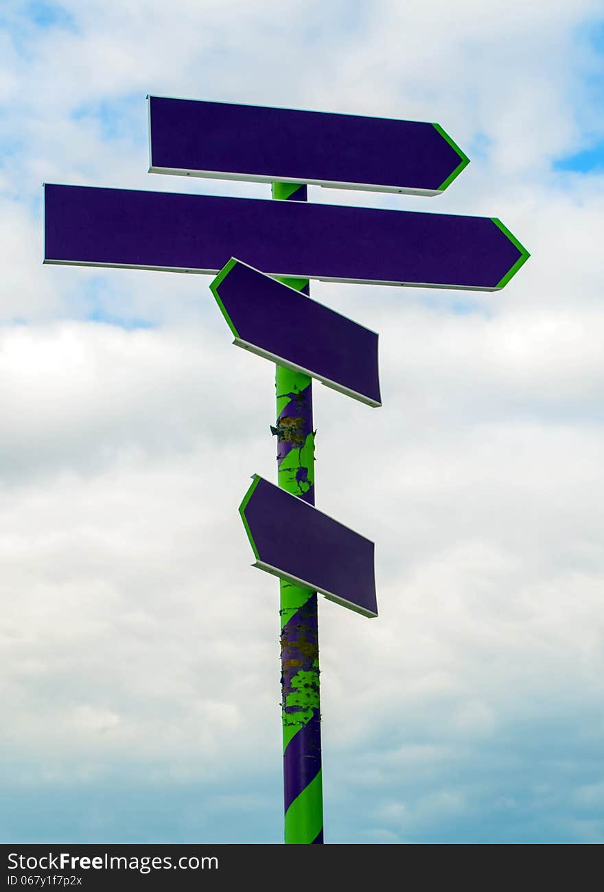 Signpost With Arrows Pointing On Sky