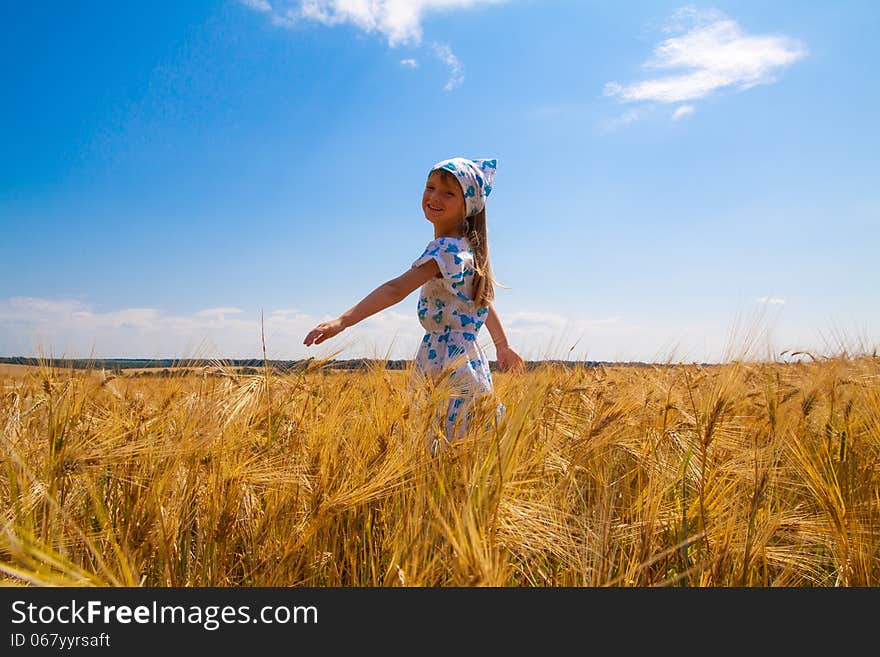 Beautiful happy little girl in a meadow summer time. Beautiful happy little girl in a meadow summer time