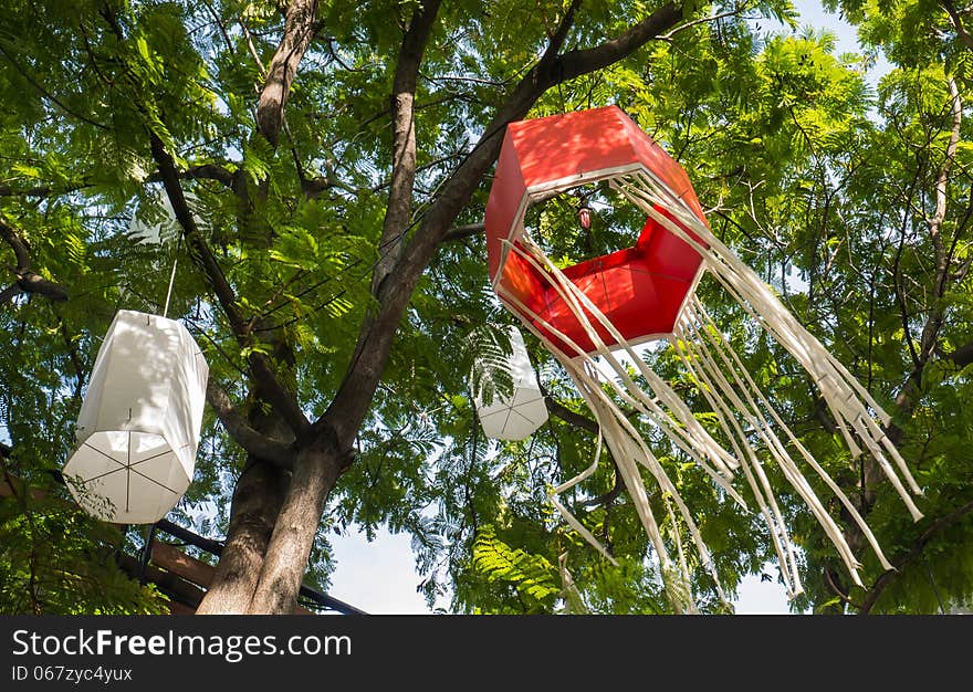 Red paper Japanese lantern hang on the tree. The lantern is in the wind that blows slowly. Red paper Japanese lantern hang on the tree. The lantern is in the wind that blows slowly