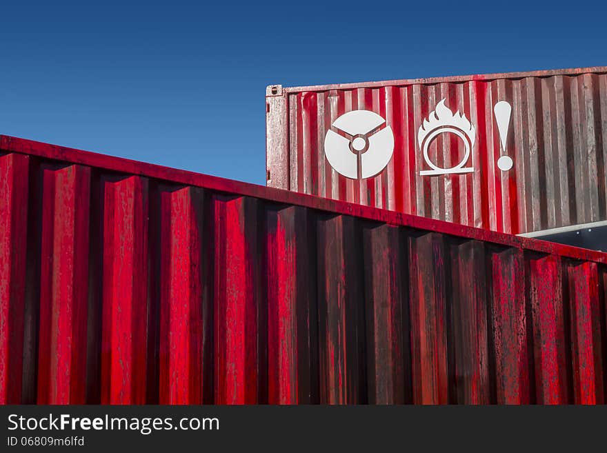 Signs on red metal container