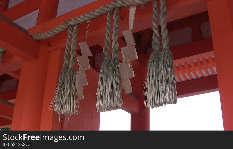 Inside the Chinese national orange arches hang decorations from the rough rope and fabric and sway in the wind. Inside the Chinese national orange arches hang decorations from the rough rope and fabric and sway in the wind