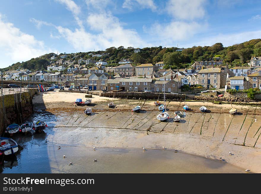 Mousehole harbour Cornwall England UK Cornish fishing village with blue sky and clouds. Mousehole harbour Cornwall England UK Cornish fishing village with blue sky and clouds