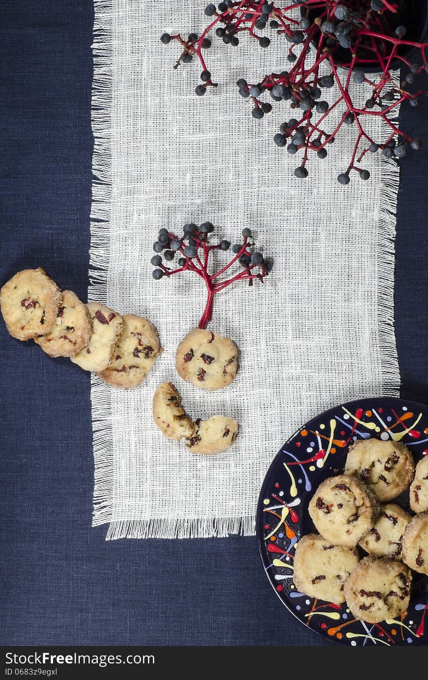 Porcelain dishes and cookies with cranberries. From series Playing with Color