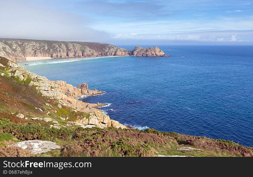 Coast of Cornwall England in autumn with mist and blue sky