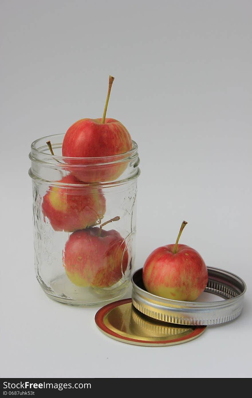 Crabapples stacked in a sealer jar isolated on a white background. Crabapples stacked in a sealer jar isolated on a white background.