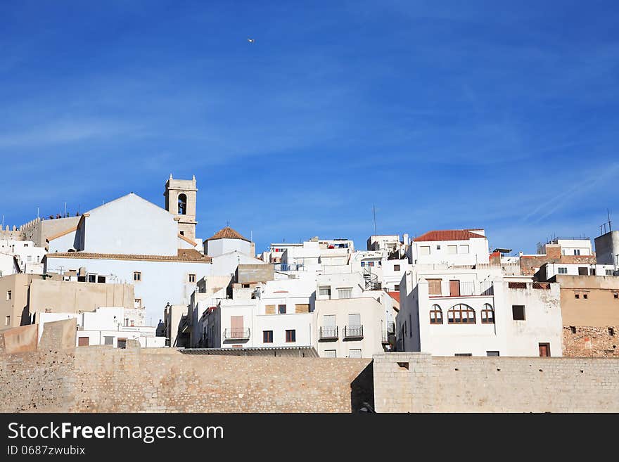 View of old Spanish Mediterranean town Peniscola against blue sky