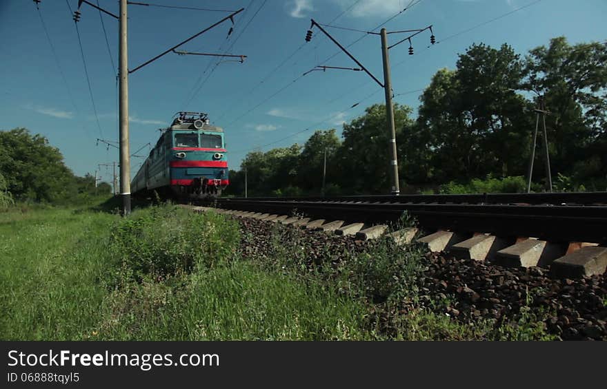 Sunny day. Countryside. Passenger train approaching and passing by. Sunny day. Countryside. Passenger train approaching and passing by